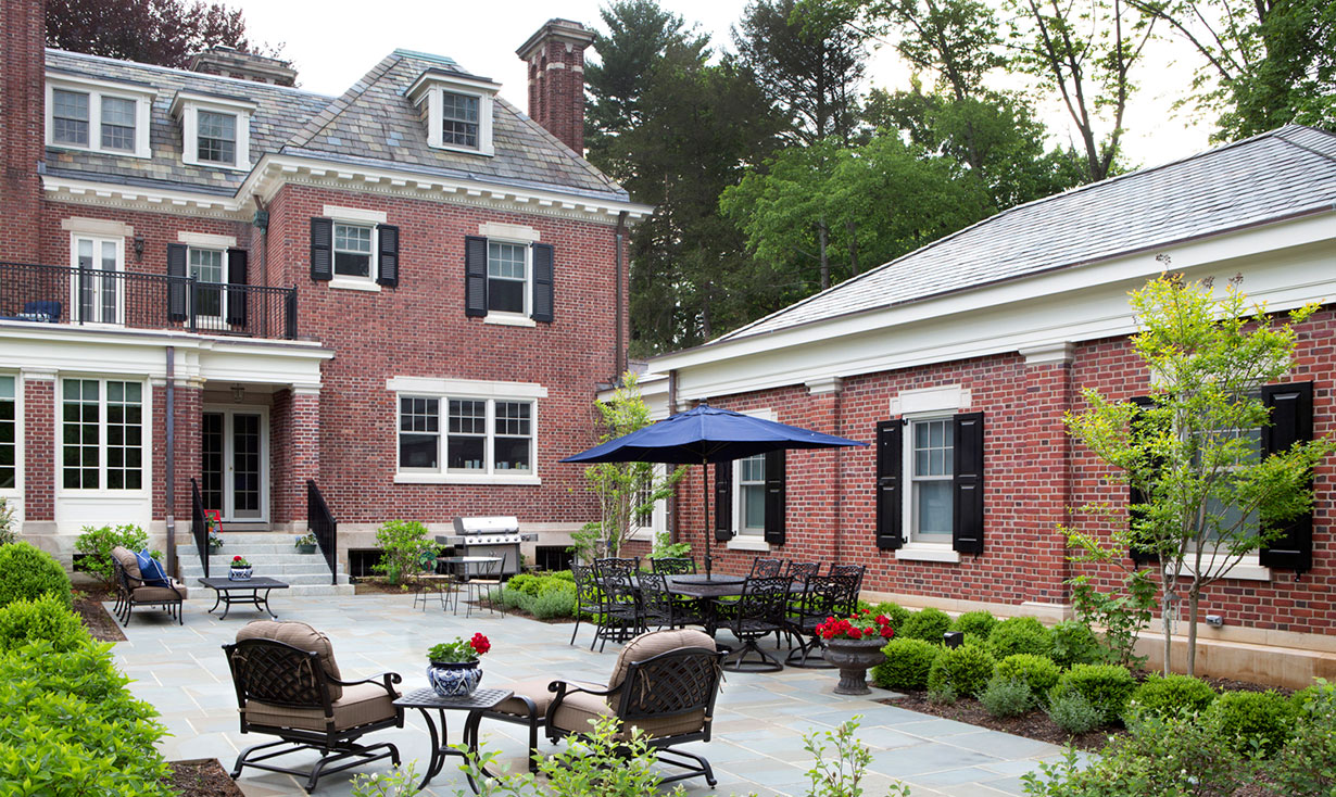 The new three-car garage and mudroom addition were designed and built by our Princeton architects and design-build team. Great efforts were made to match the original brick and limestone trim of the existing home.