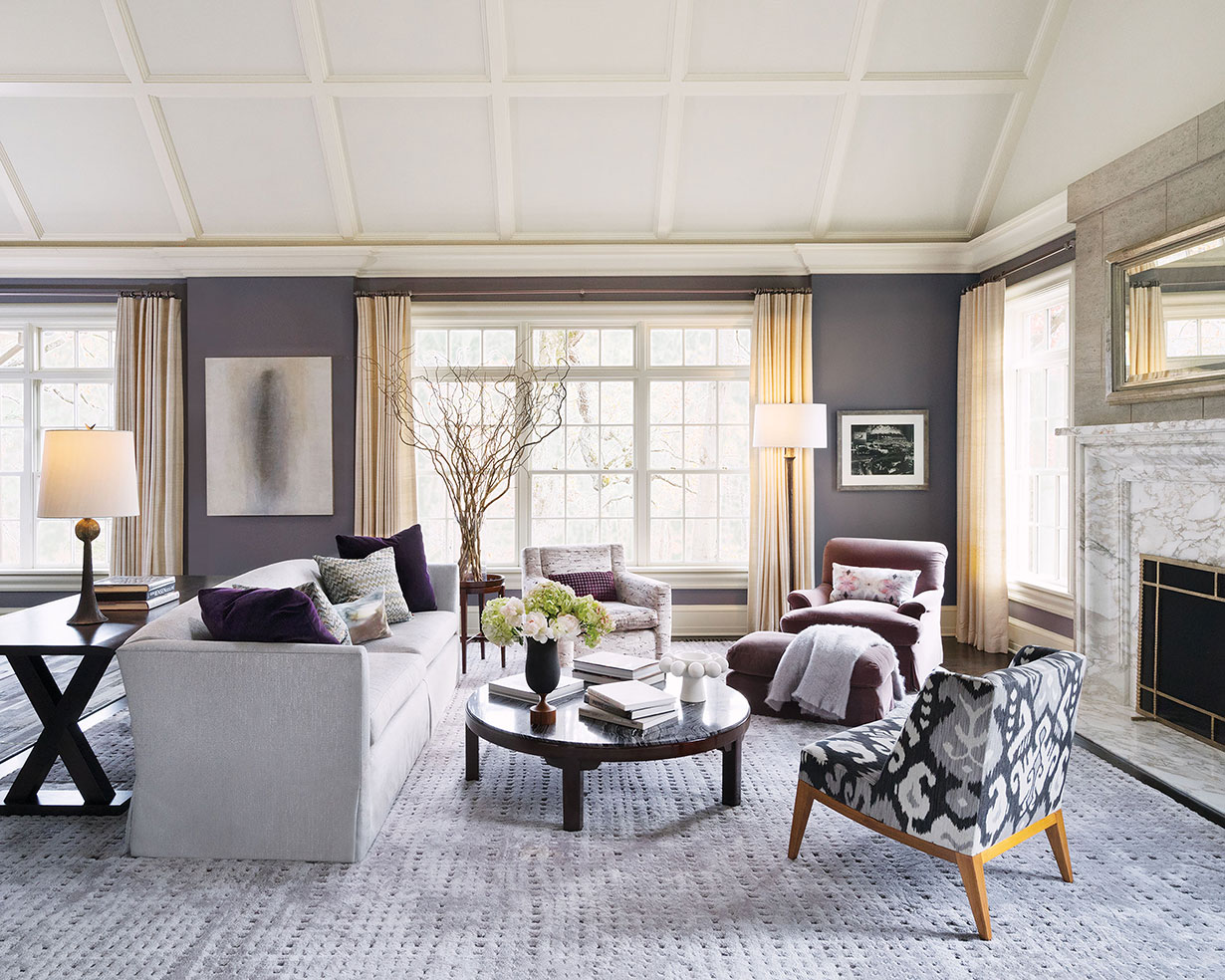 LIVING ROOM | The living room is elegant and very livable. A small-scale vintage chair upholstered in a bold ikat print joins comfortably with treasured vintage pieces in a conversation grouping around a Kenya black marble-topped cocktail table.