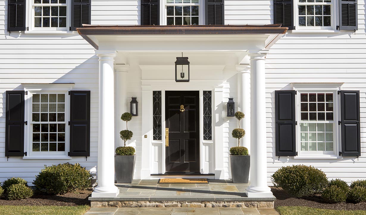 Portico at the front door added interest to the formerly “flat” facade.