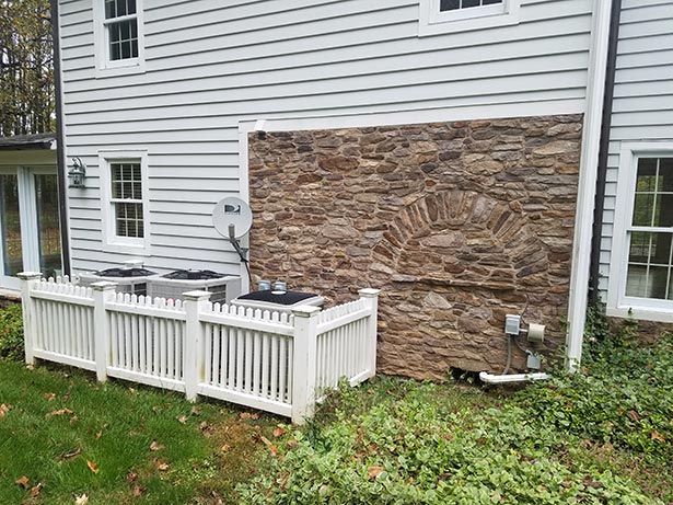 Before: This exterior stone wall was part of an older addition by the husband’s parents to tie it
                in with the original farmhouse.