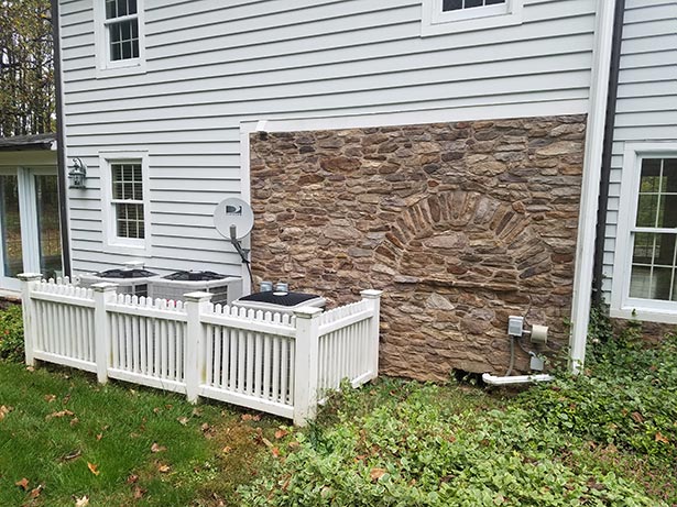 Before: This exterior stone wall was part of an older addition by the husband’s parents to tie it
                in with the original farmhouse.