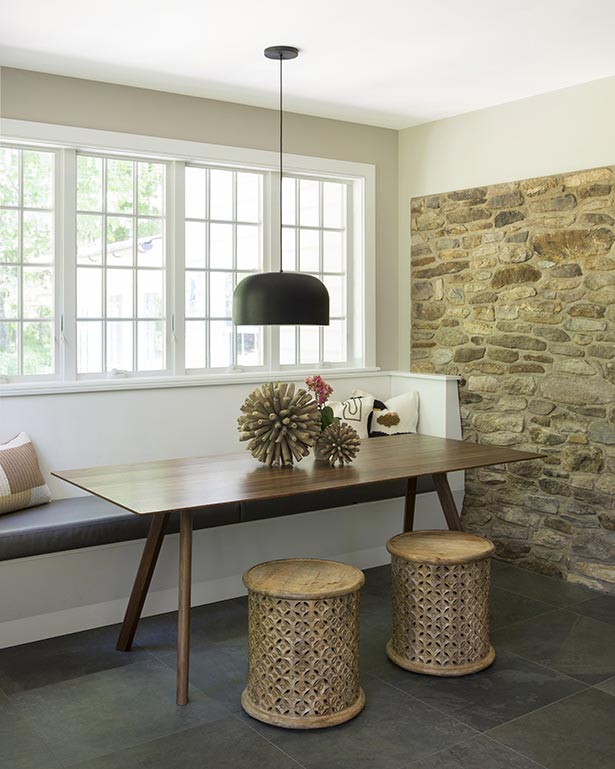 After: Another must-have on the list was a comfy breakfast nook for the whole family. When facing the
                sink, it’s located to the right of the island in an alcove.