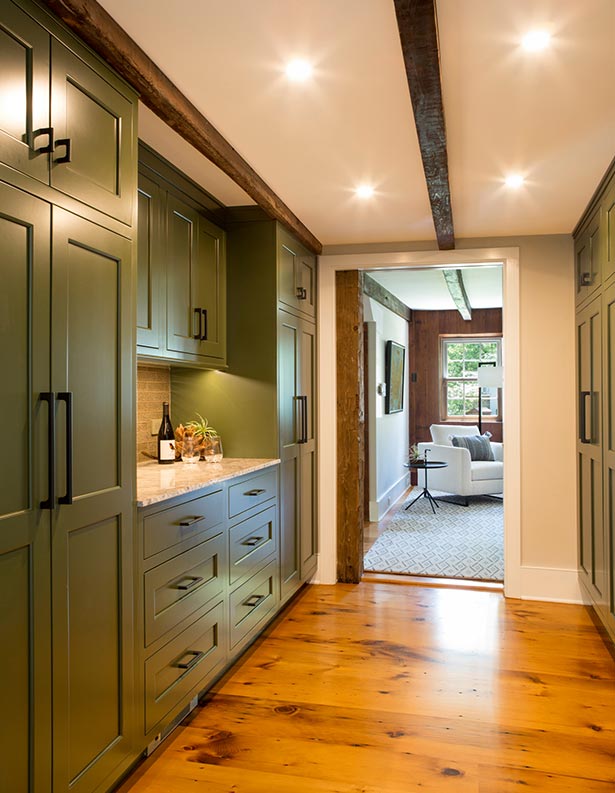 The new butler’s pantry in the original farmhouse features deep green Shaker-style cabinetry that’s
                a lovely fit for the historic space.