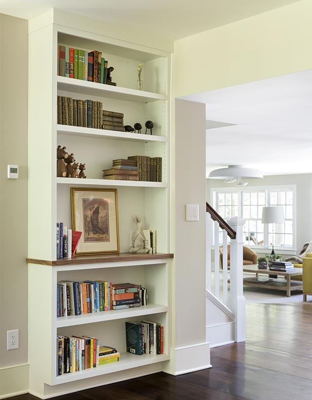 New built-in bookshelves add color on the walk back to the kitchen.
