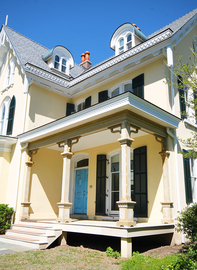 Finishing up, the porch trim is to be painted white, nicely offsetting the home’s light yellow stucco cladding and the dark green (almost black) shutters.