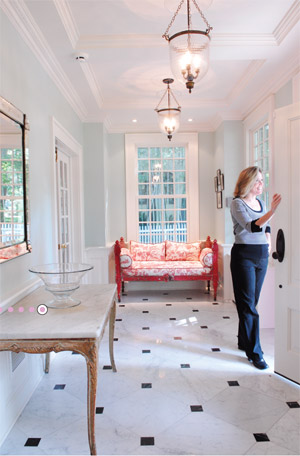 Ann Marciano, marketing manager for Lasley Brahaney Architecture and Construction, looks out the front door of the home's foyer (photos by Mark Czajkowski).