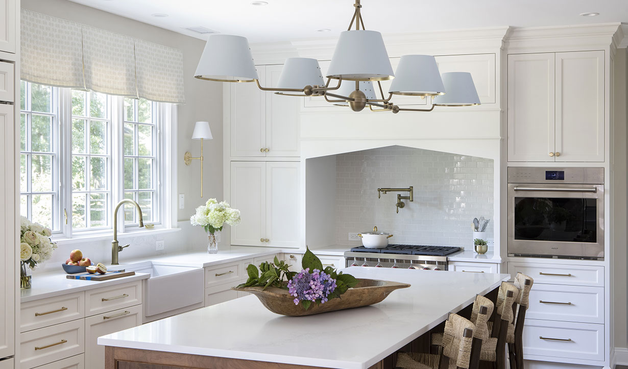 The homeowners partnered with an interior designer to bring light and freshness into their kitchen, featuring a soft blue and brass Urban Electric fixture above the island. Our Princeton architects reimagined the layout, tailoring every detail for function and flow.
