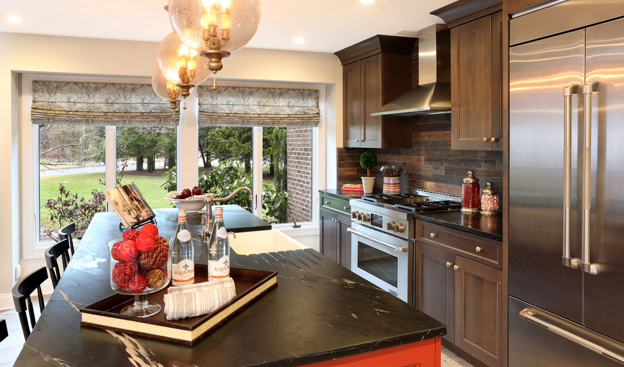 Dark wood and stainless steel kitchen designed by building company Lasley Brahaney Architecture + Construction in Princeton, NJ